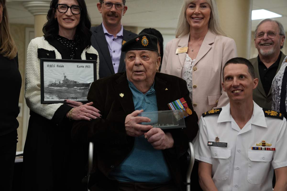 Richard Brown accepting a model ship the HMCS Haida, which he served on.