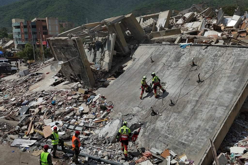 Mexican Army rescue workers search for people trapped in collapsed buildings after earthquakes struck La Guaira, Venezuela, Sunday, June 28, 2026.