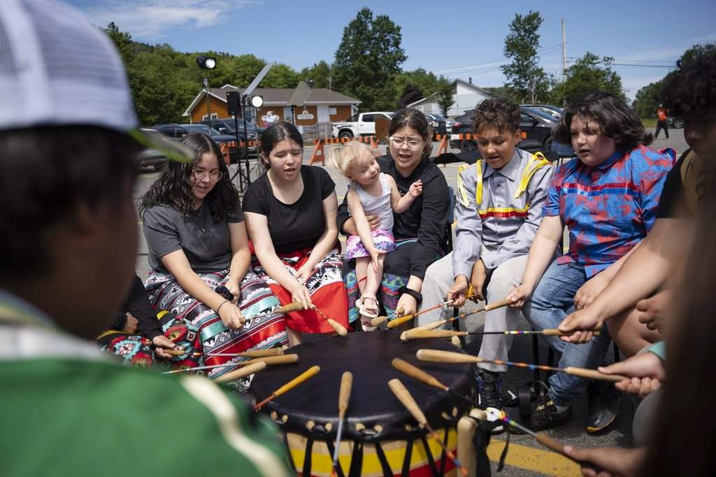 Members of the We’koqma’q Mikmaw school drum group White Bear practise before an event for National Indigenous Peoples Day in We'koqma'q First Nation, N.S., on Friday, June 21, 2024. THE CANADIAN PRESS/Darren Calabrese.