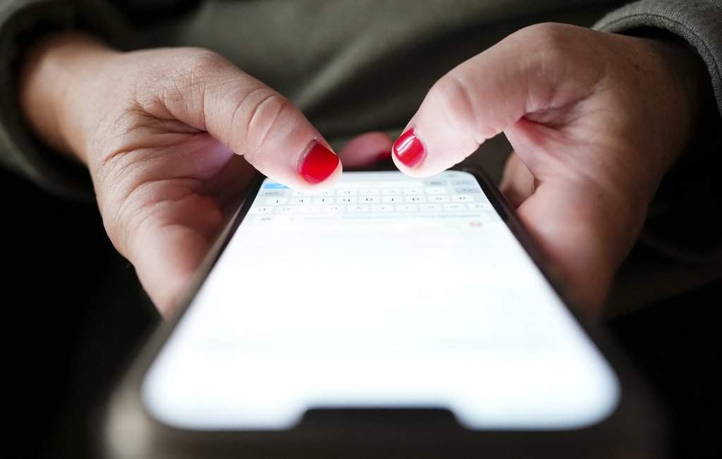 A person types on a cellphone in Ottawa on, Dec. 15, 2025. THE CANADIAN PRESS/Sean Kilpatrick.