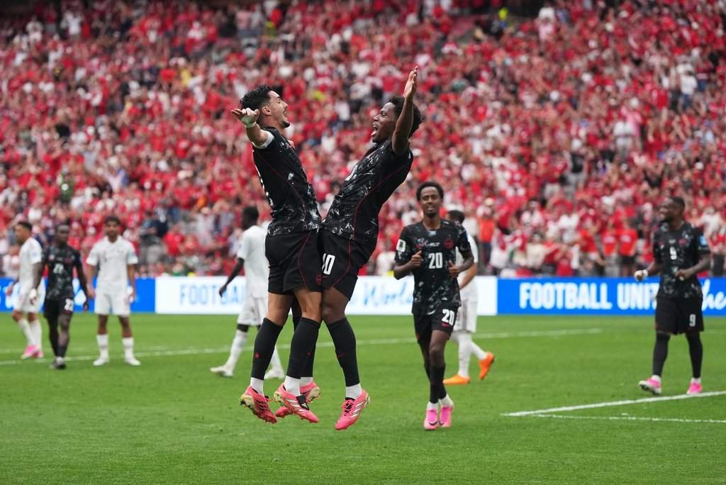 Canada’s Jonathan David (right) celebrates his goal against Qatar with Stephen Eustaquio (7) during the first half of a World Cup Group B soccer match, in Vancouver, on Thursday, June 18, 2026.