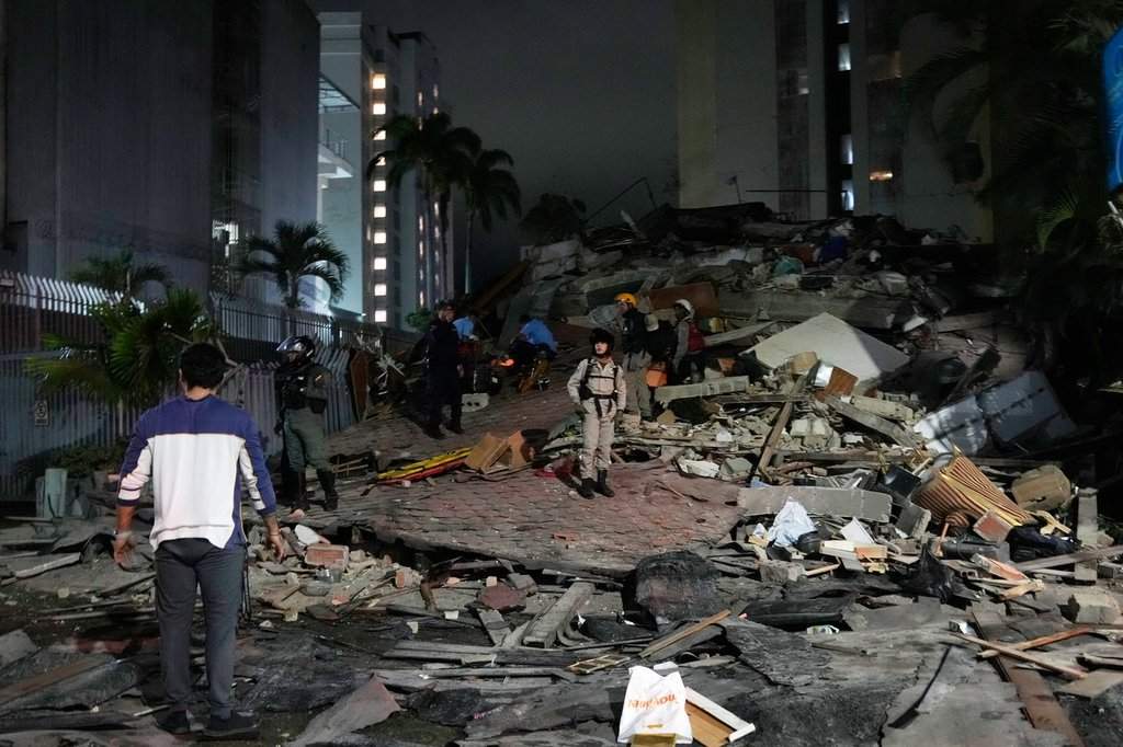 People walk amid debris after an earthquake in Caracas, Venezuela, Wednesday, June 24, 2026.