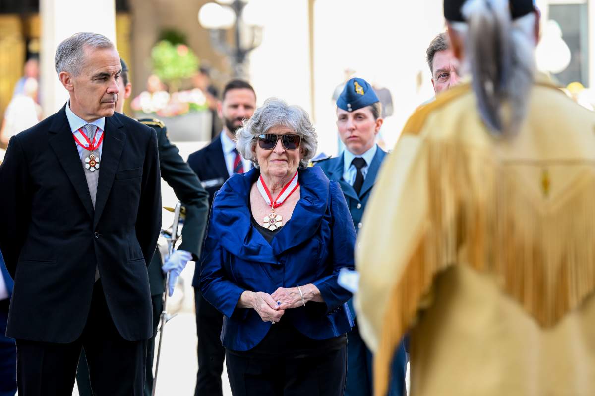 Gov. Gen. Louise Arbour, centre, and Prime Minister Mark Carney look on ahead of a drum circle during her installation ceremony at the Senate of Canada in Ottawa, on Monday, June 8, 2026.