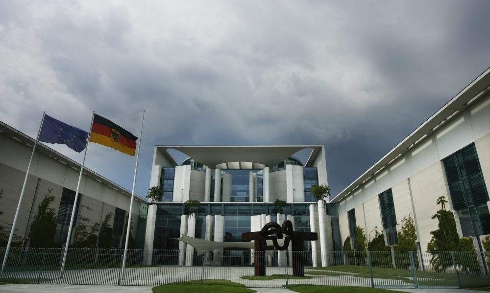 FILE – Dark clouds cover the sky over the frontside of the German Chancellery in Berlin, May 26, 2009.