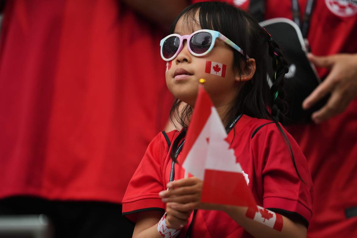 A young fan of Canada watches as teams arrive prior to the World Cup Group B soccer match between Canada and Qatar in Vancouver, British Columbia, Thursday, June 18, 2026. (AP Photo/Abbie Parr)