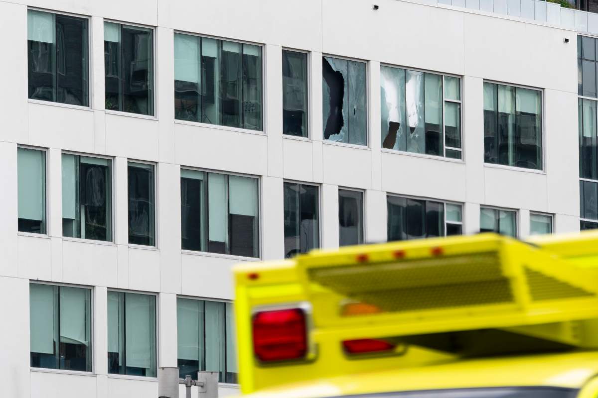 Broken windows are seen at the scene of a shooting in Montreal on Monday, June 22, 2026.