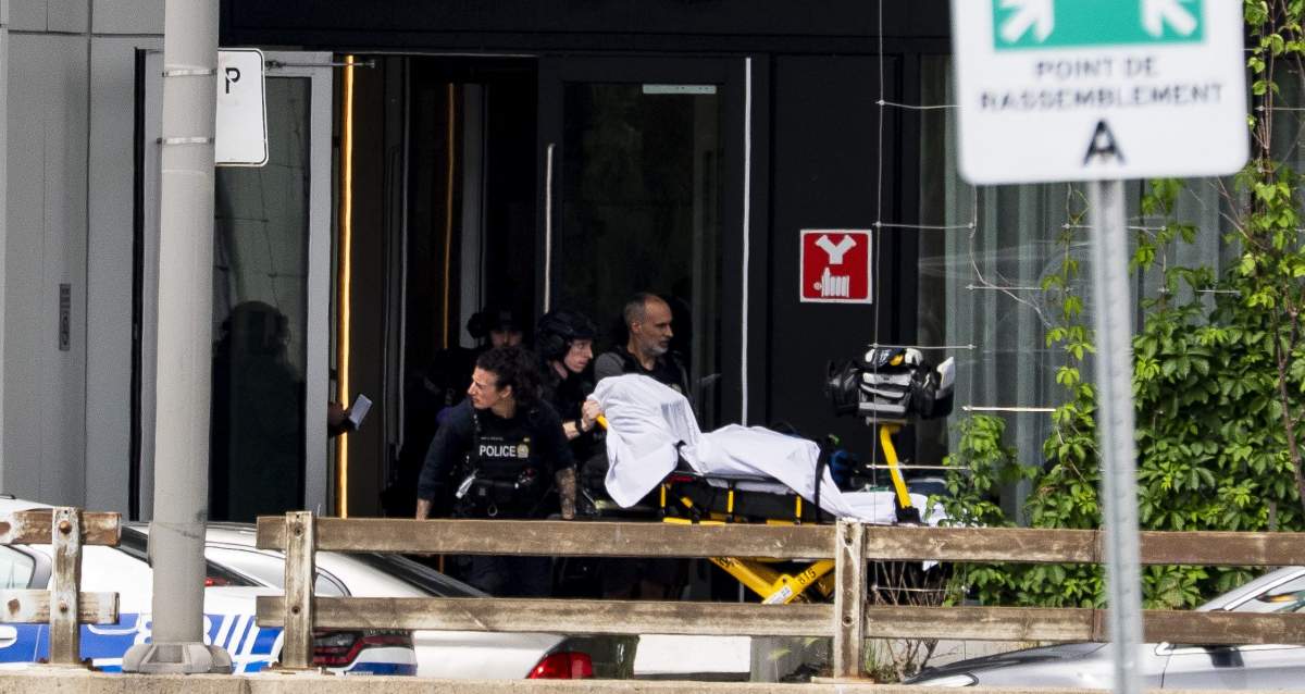 Montreal police bring a stretcher out of a building at the scene of a shooting in Montreal on Monday, June 22, 2026.