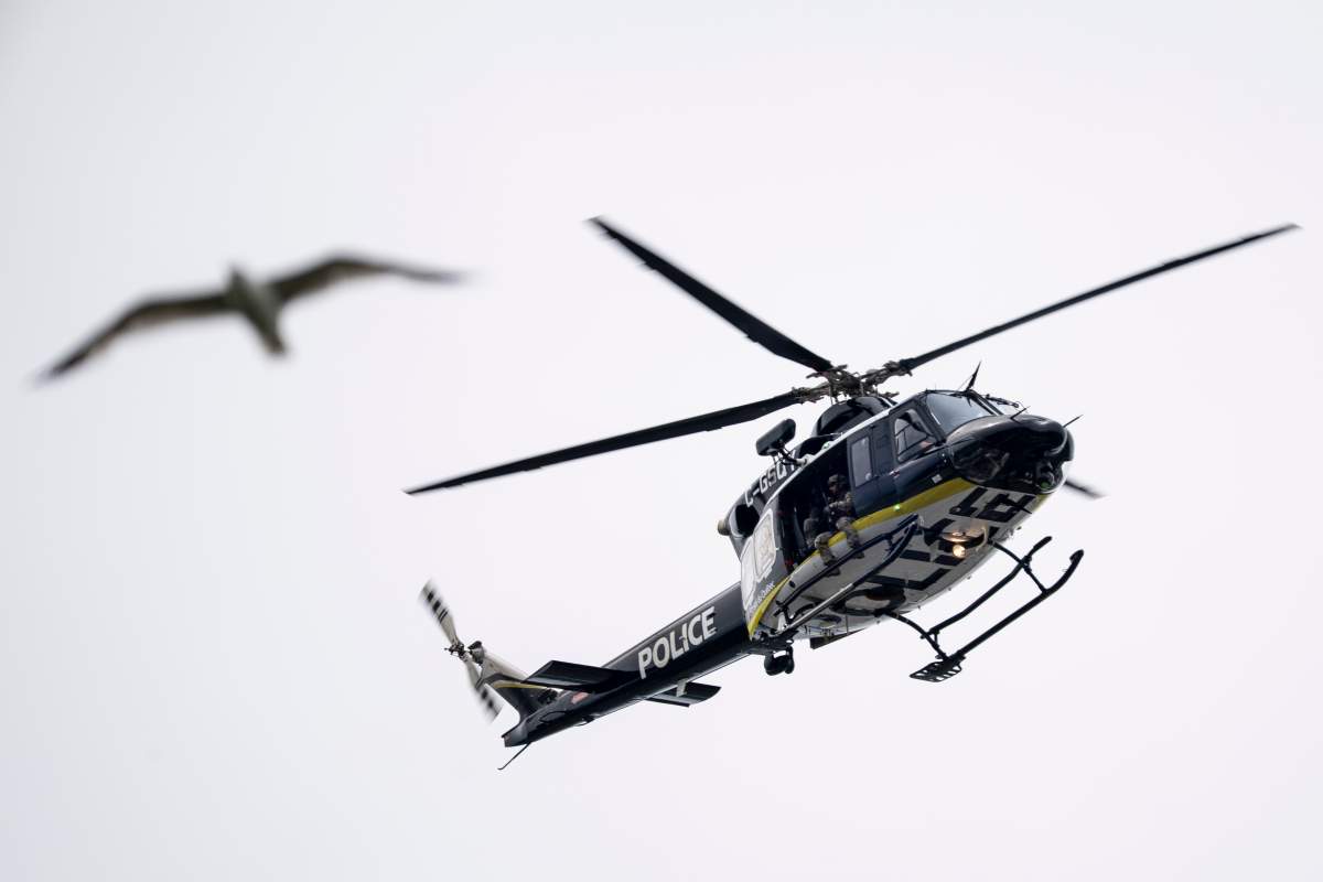 A Montreal police helicopter surveil the area near the scene of a shooting in Montreal on Monday, June 22, 2026.