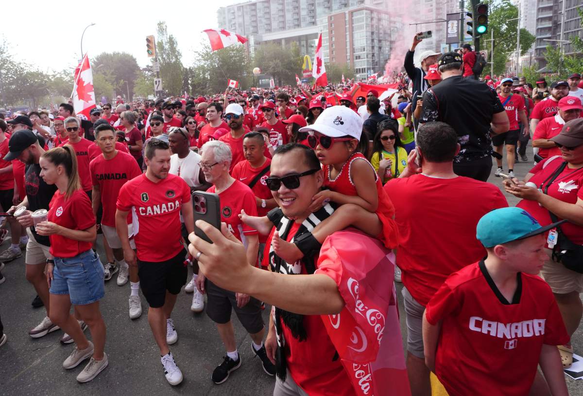 Canada fans march to B.C. Place stadium before Canada and Switzerland play a World Cup Group B soccer match, in Vancouver, on Wednesday, June 24, 2026. THE CANADIAN PRESS/Ethan Cairns