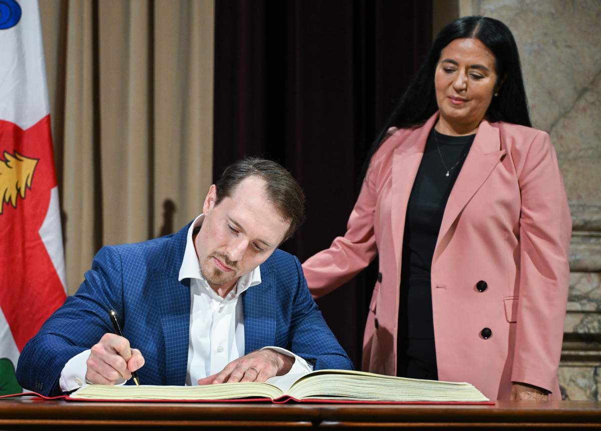 Montreal mayor Soraya Martinez Ferrada looks on as Montreal Canadiens player Brendan Gallagher signs the golden book during a ceremony naming him a Citizen of Honour at City Hall in Montreal, on Thursday, June 25, 2026.