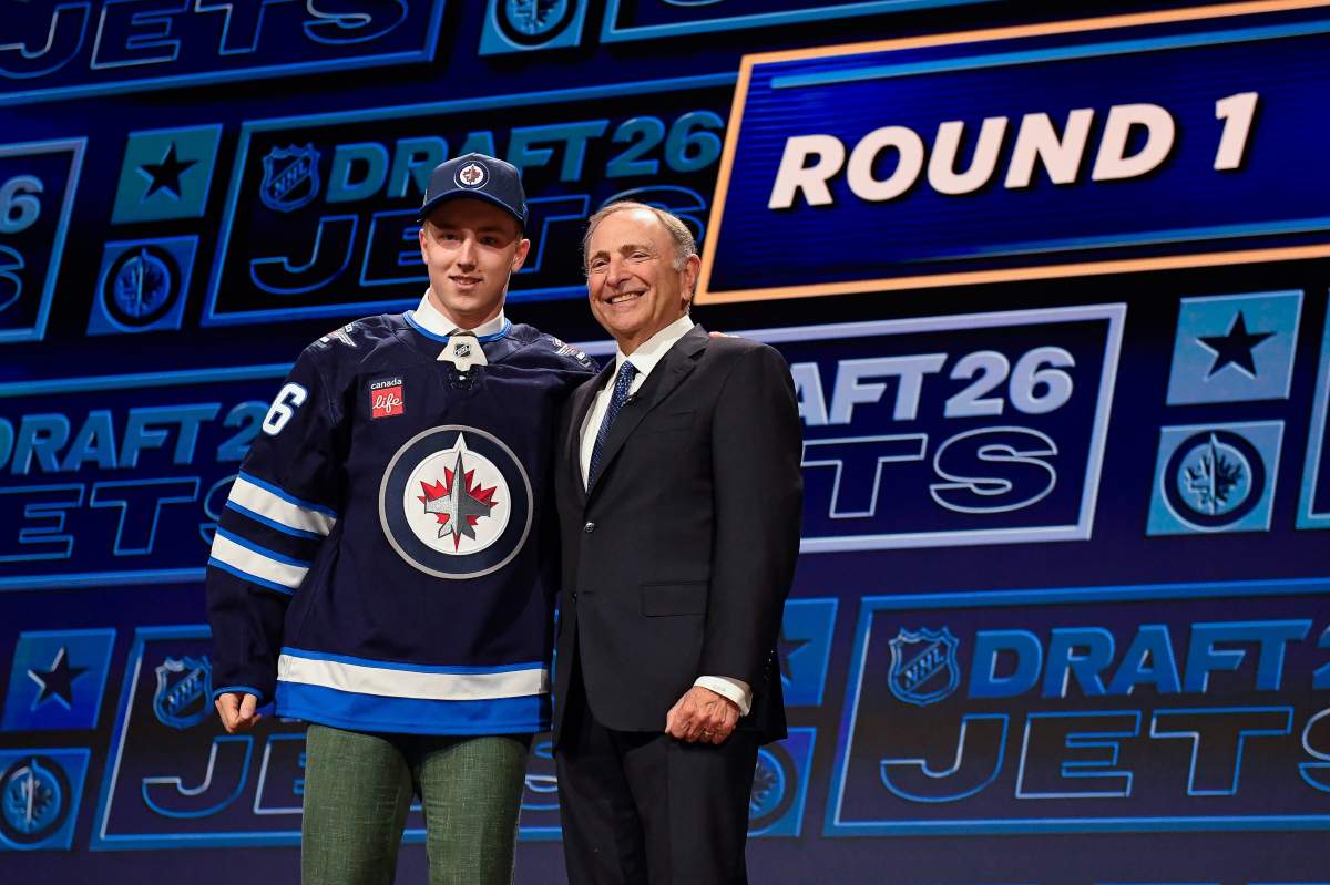 Viggo Bjorck, left, stands with NHL Commissioner Gary Bettman, right, after being drafted by the Winnipeg Jets during the NHL hockey draft Friday, June 26, 2026, in Buffalo, N.Y. (AP Photo/Adrian Kraus).
