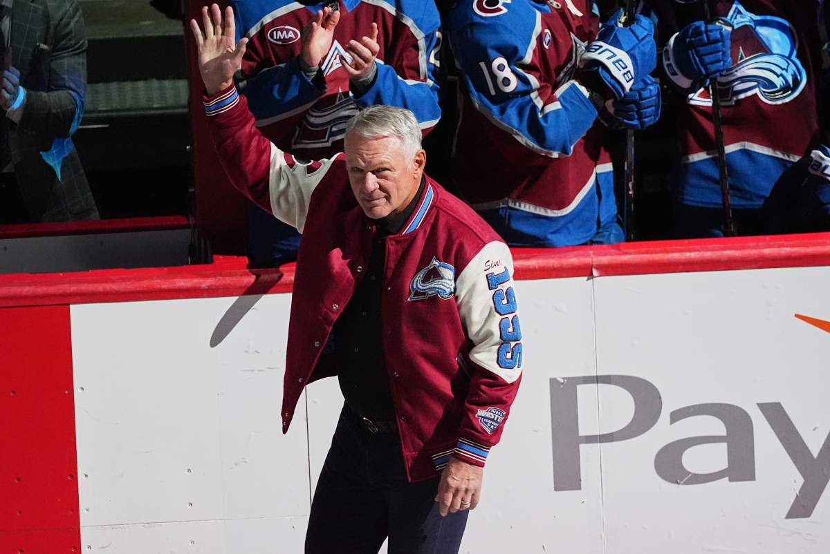 Claude Lemieux waves as he is introduced during a ceremony to honor members from the 1996 Stanley Cup Championship team of the Colorado Avalanche before an NHL hockey game against the Florida Panthers Thursday, Dec. 11, 2025, in Denver.