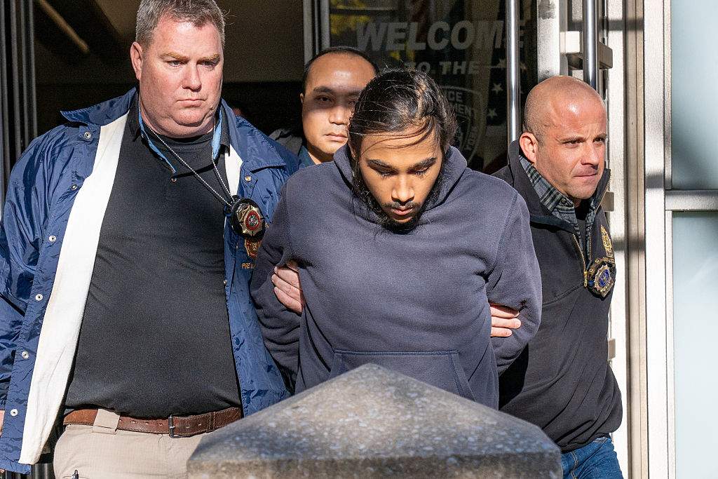 Hiram Carrero, 19, accused of lighting a homeless man on fire aboard a northbound number 3 train, is taken from the New York Police Department 9th Precinct in Manhattan on Thursday Dec. 4, 2025.