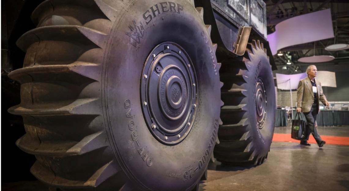 A delegate walks past an all-terrain vehicle at the Global Energy Show in Calgary on Tuesday.