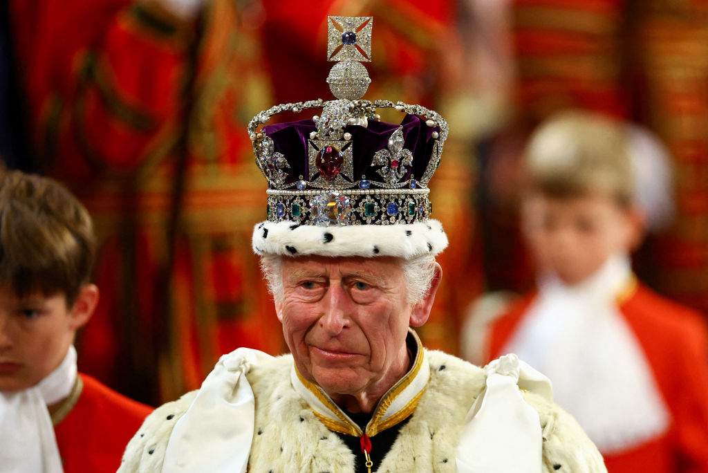 Britain's King Charles III, wearing the Imperial State Crown and the Robe of State, processes through the Royal Gallery during the State Opening of Parliament at the Houses of Parliament, in London, on July 17, 2024.