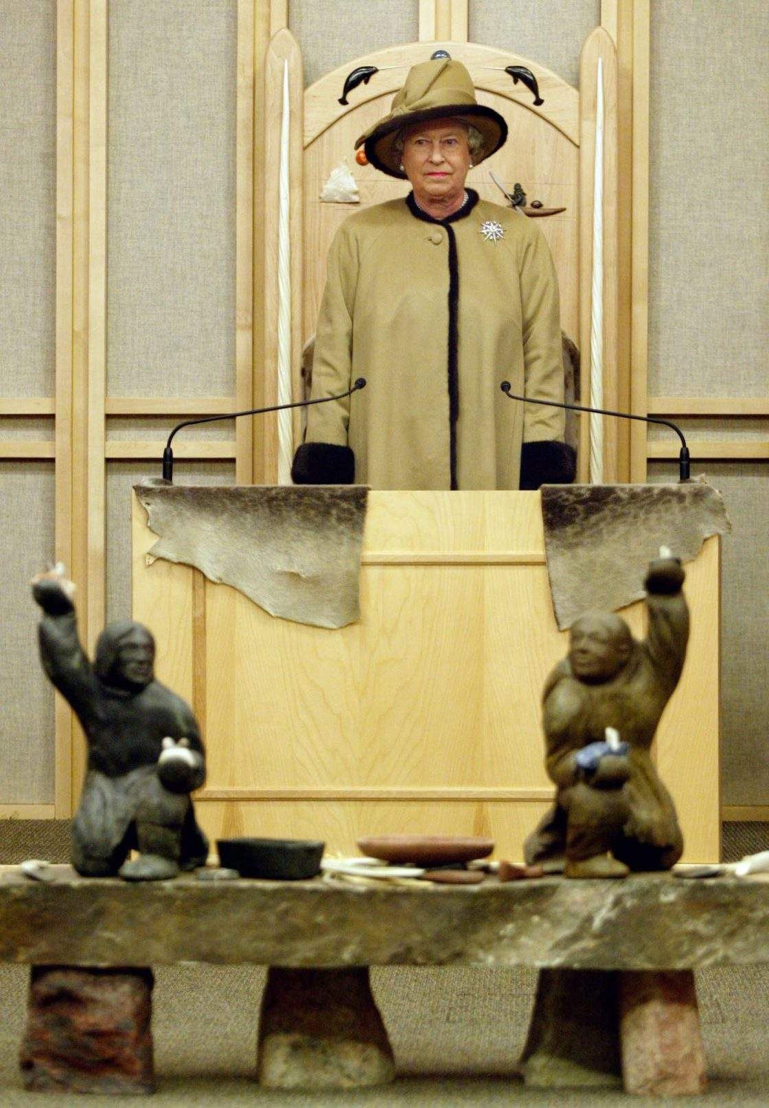 FILE – Queen Elizabeth II listens to the royal anthem as she stands at the throne at the Nunavut Legislative Assembly in Iqaluit Friday, Oct. 4, 2002.