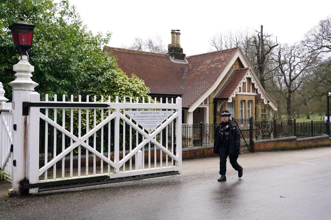 A police officer passes the gate of the Royal Lodge in Windsor, Thursday, Feb. 19, 2026 after Andrew Mountbatten-Windsor was arrested by British police on suspicion of misconduct in public office.