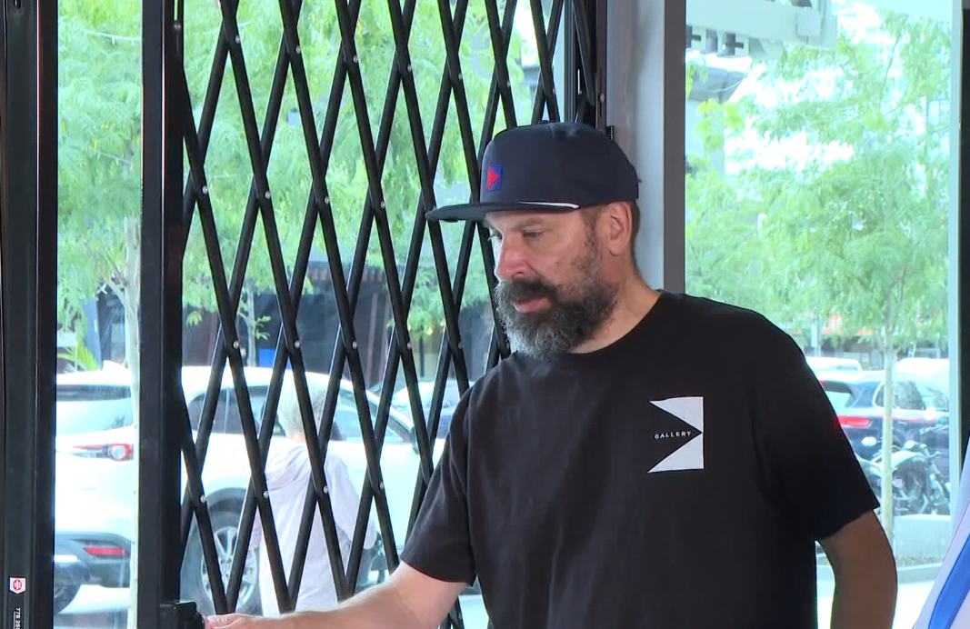 Todd Daniels, owner of Gallery street clothing, showing his security gates he bought.