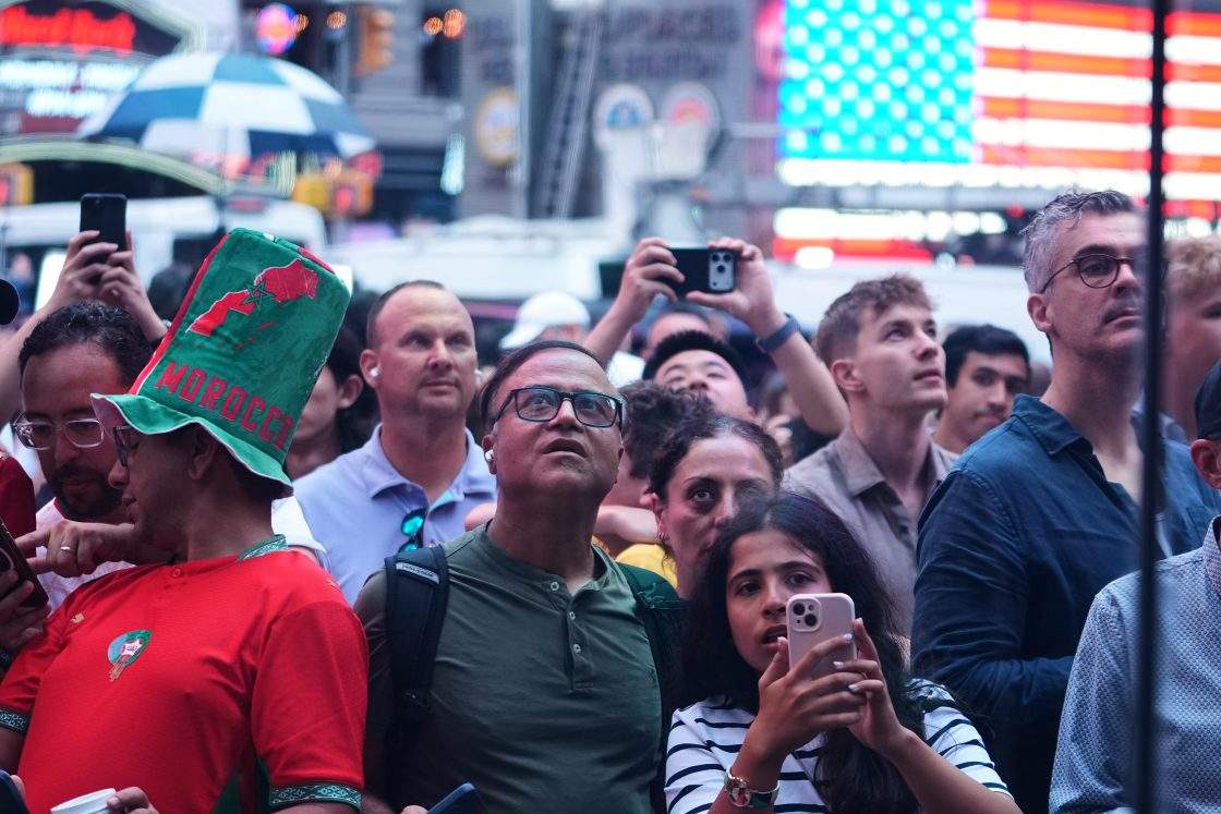 People watch from outside the Nasdaq MarketSite during a bell ringing ceremony for the IPO of SpaceX in New York, Friday, June 12, 2026, in New York.