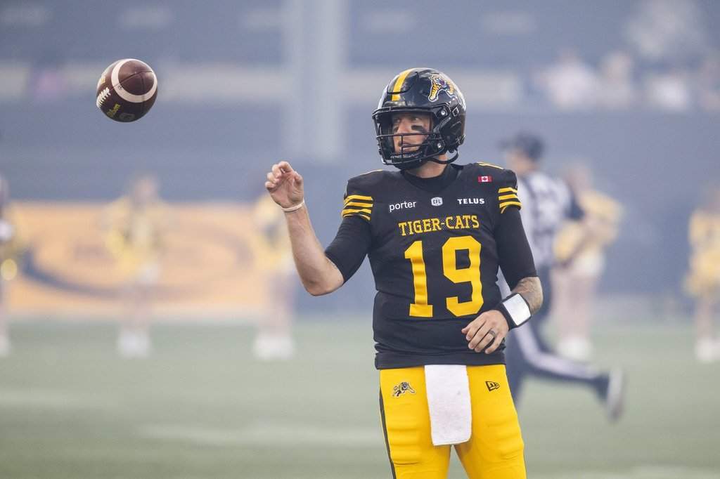 Hamilton Tiger-Cats' Bo Levi Mitchell (19) warms up ahead of CFL football action against the B.C. Lions in Hamilton on Friday, June 19, 2026. THE CANADIAN PRESS/Nick Iwanyshyn.