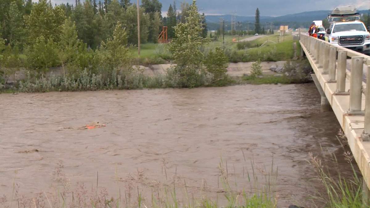 Crews from the City of Calgary are seen measuring the streamflow in the Elbow River, near the Springbank offstream reservoir on Monday.