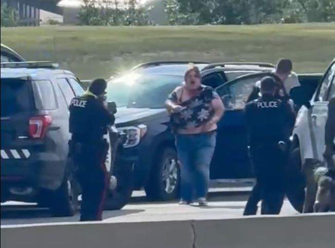 This picture taken from a viewer video shows the woman ignoring the commands of officers and continuing to advance towards them with what appearst to be something in her right hand.