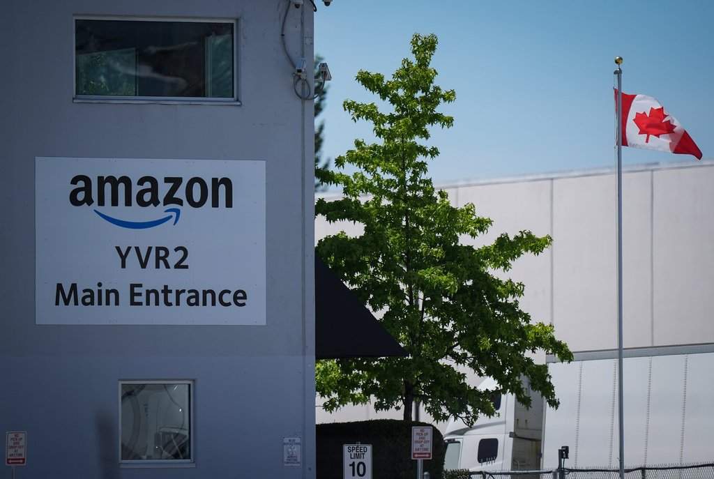 A Canadian flag flies outside Amazon's YVR2 fulfillment centre, in Delta, B.C., on Friday, July 11, 2025. 
