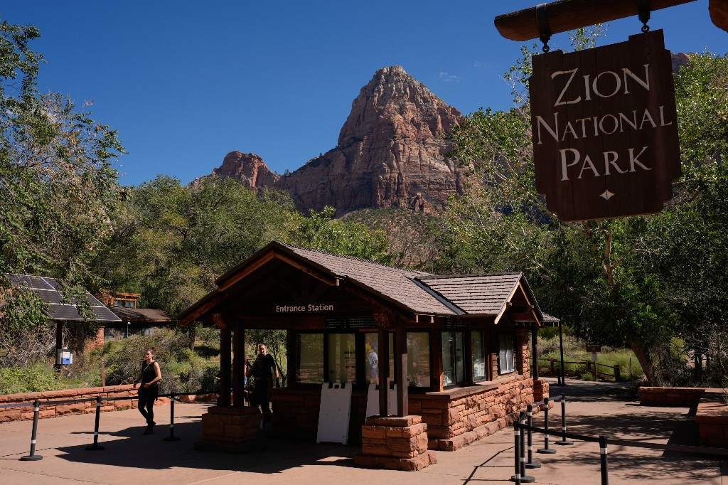 A file photo of people walking by an unstaffed entrance station at Zion National Park, Wednesday, Oct. 1, 2025, near Springdale, Utah.