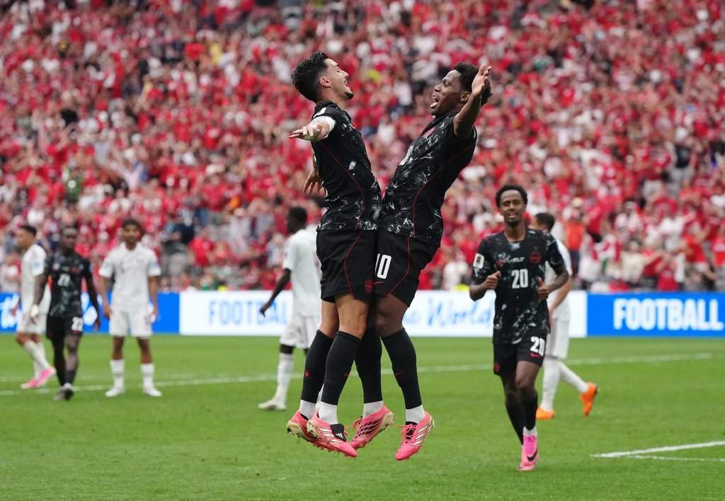 Canada's Jonathan David (right) celebrates his goal against Qatar with Stephen Eustaquio (7) during the first half of a World Cup Group B soccer match, in Vancouver, on Thursday, June 18, 2026. THE CANADIAN PRESS/Darryl Dyck.