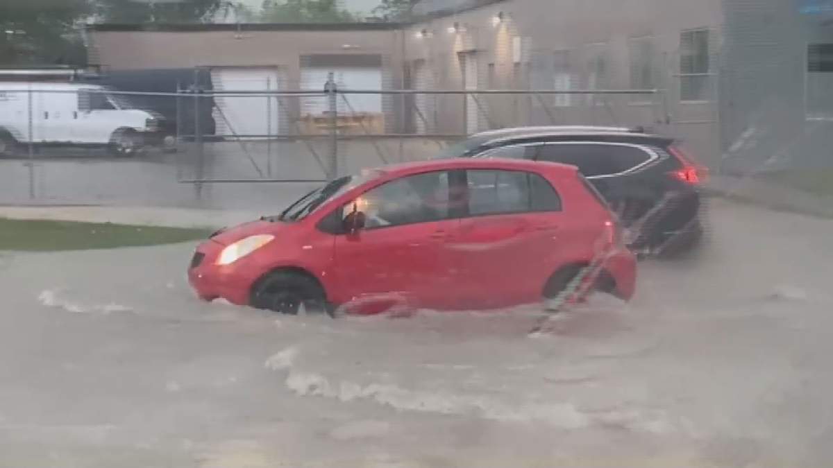 A vehicle moves through flooded roads on June 9, 2026 in Winnipeg.