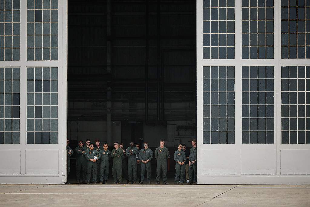 Airmen watch as President Donald Trump and first lady Melania Trump arrive at Lackland Air Force Base before heading off to Kerrville, Texas where they plan to visit with state and local leaders, first responders and victims of last week's flash flooding on July 11, 2025 in San Antonio, Texas.