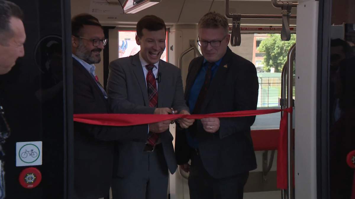 Calgary Mayor Jeromy Farkas takes part in a ribbon cutting for one of three new light rail transit vehicles that are going into service this week.