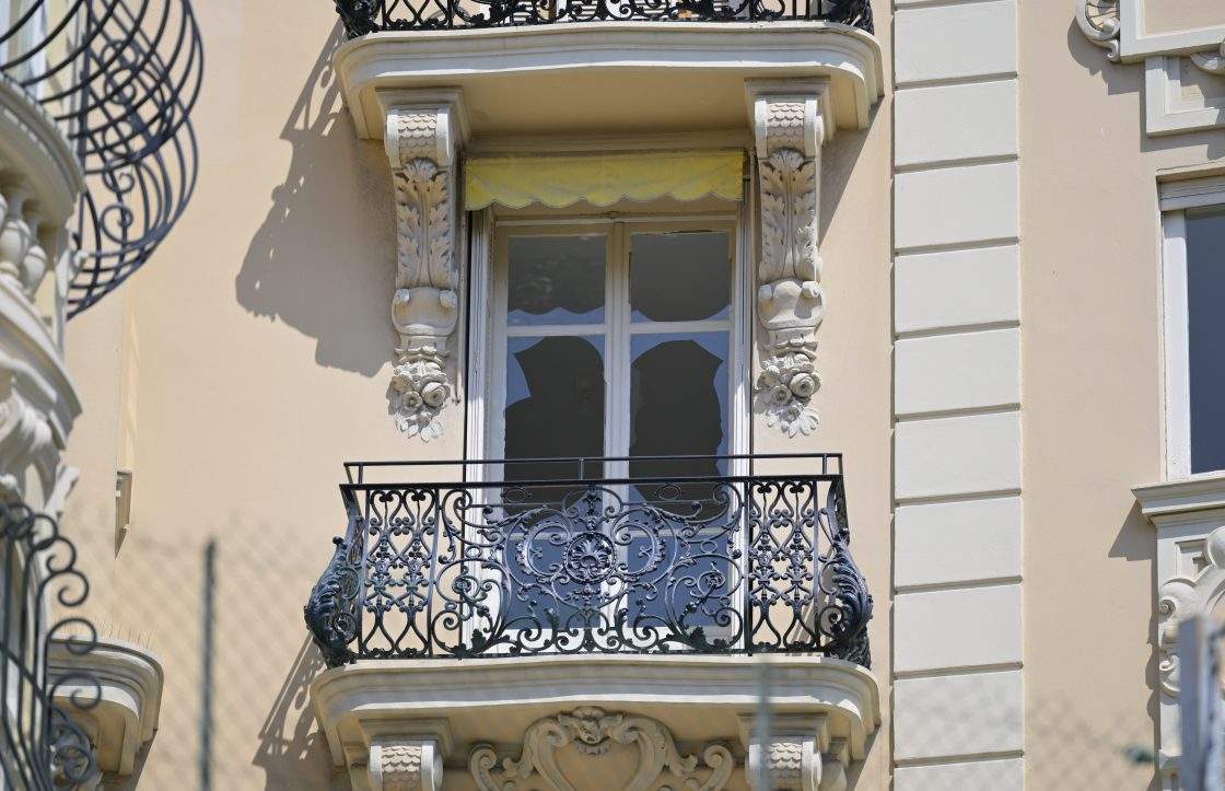 A shattered window of a nearby residential building is seen in Monaco, Tuesday, June 30, 2026, a day after an explosive device seriously injured three people at a nearby residential building.