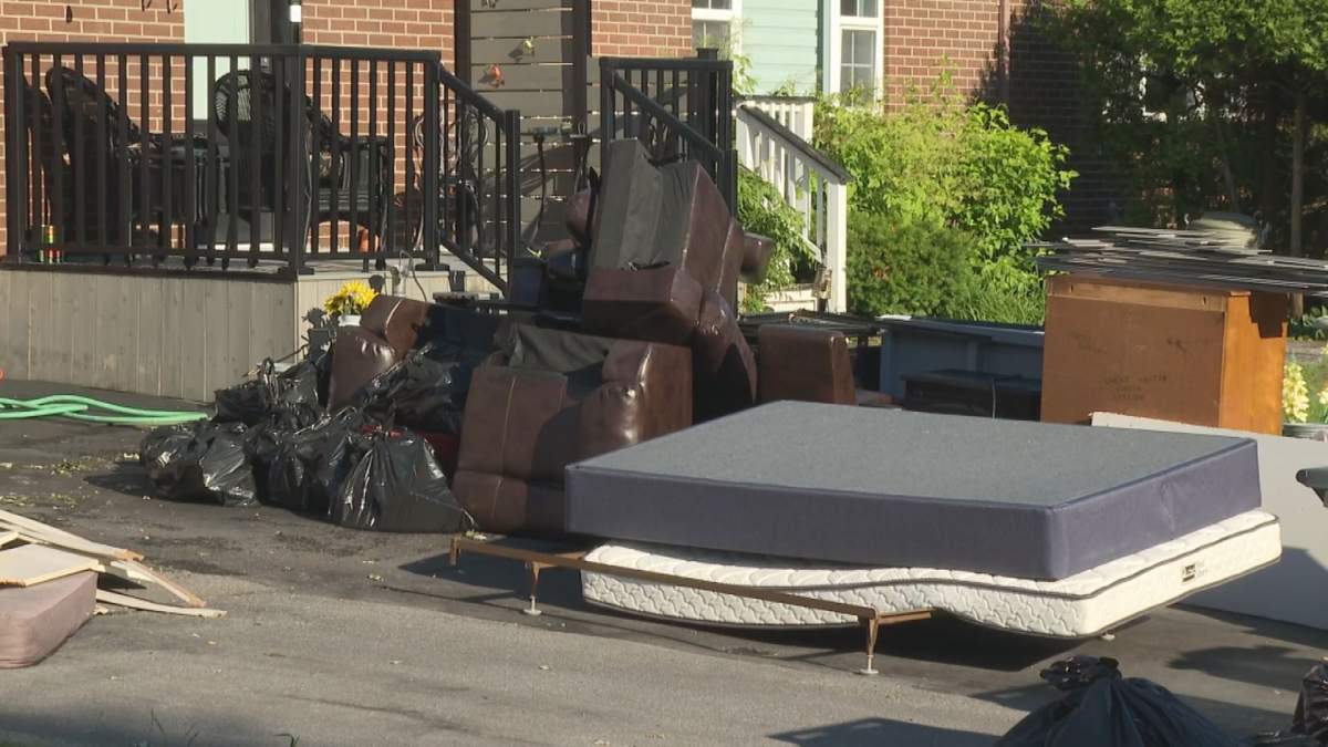 A mattress and other items sit on the driveway of a Pierrefonds, Que. resident after intense flooding this past weekend.
