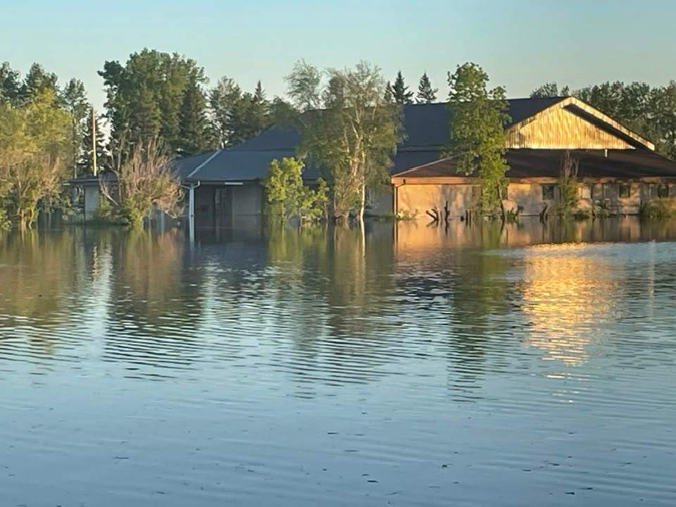 Water nears a home in Swan River, Man. on June 8, 2026.