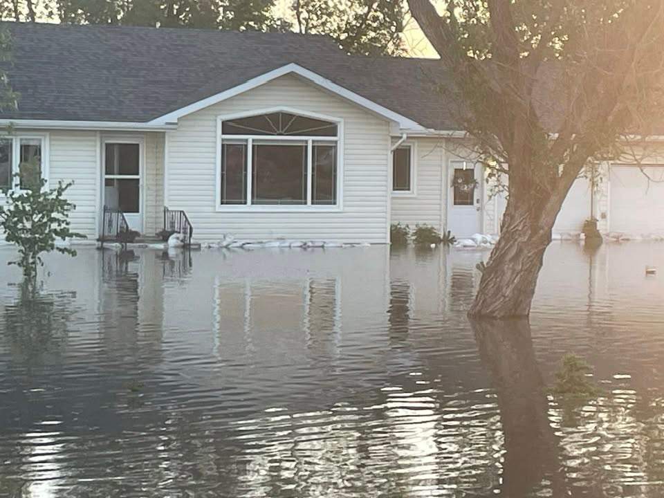 Sandbags line a home in Swan River, Man. after significant flooding on June 8, 2026.