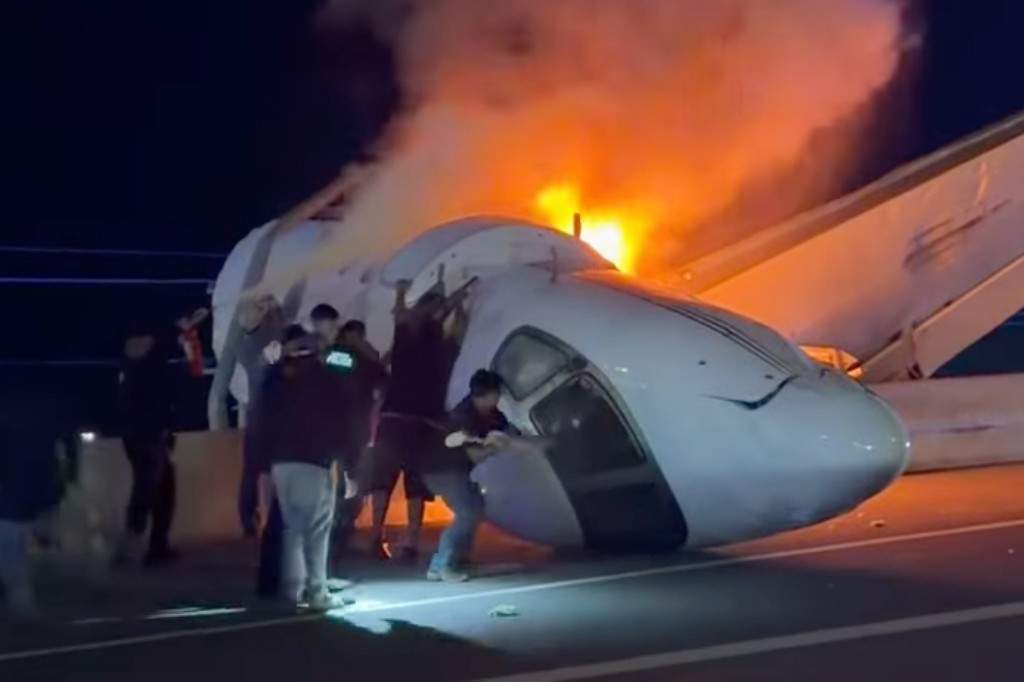 People attempt to pull passengers out of a plane after it crashed on a highway Tuesday, June 16, 2026, in Laredo, Texas.
