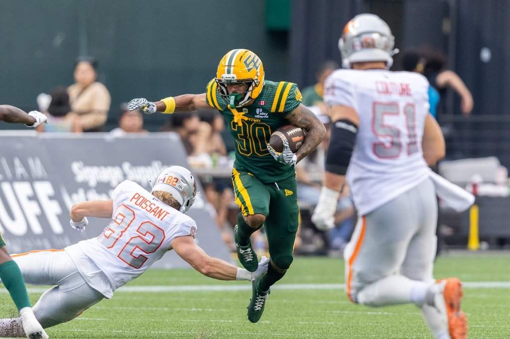 Edmonton Elks' Tyrell Ford (30) returns an interception and breaks a tackle against BC Lions' Kieran Poissant (82) during first half CFL football action in Edmonton on Friday, July 17, 2026. THE CANADIAN PRESS/Timothy Matwey.