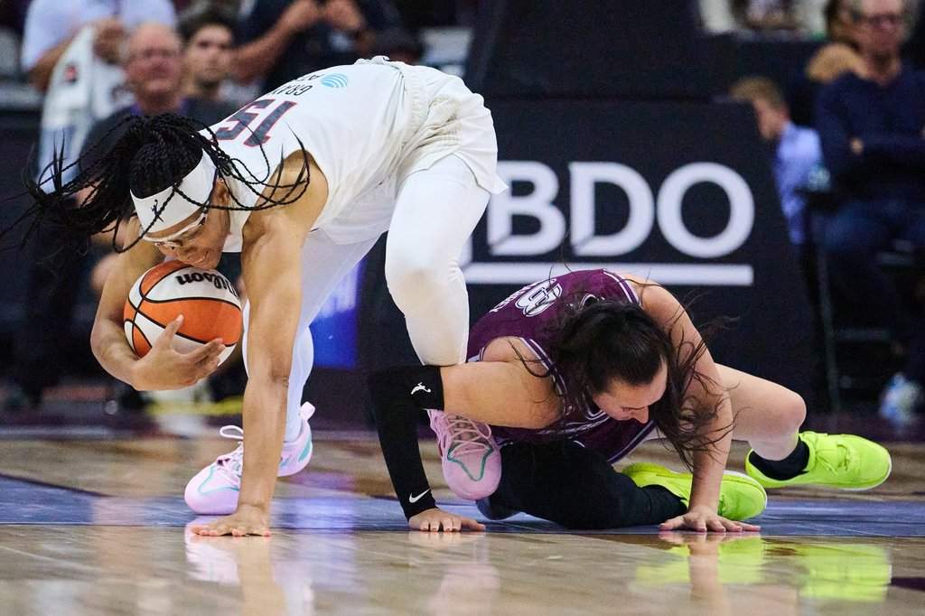 Atlanta Dream's Allisha Gray (15) and Toronto Tempo's Marina Mabrey (3) collide as they vie for the ball during second half WNBA basketball action in Toronto, Friday, July 17, 2026. THE CANADIAN PRESS/Sammy Kogan.