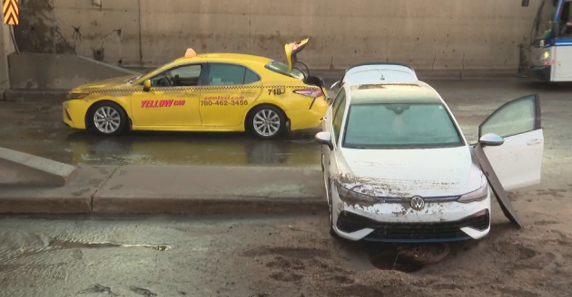 Vehicles left abandoned on 127 Street between 126 Avenue and 127 Avenue due to localized flooding.