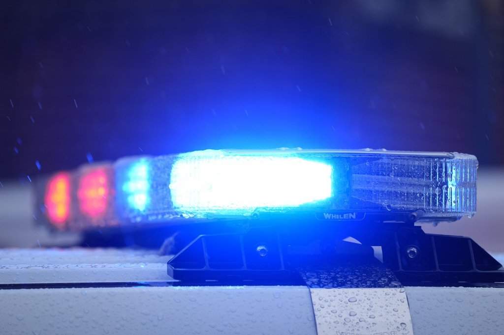 Lights on a parked police vehicle flash .