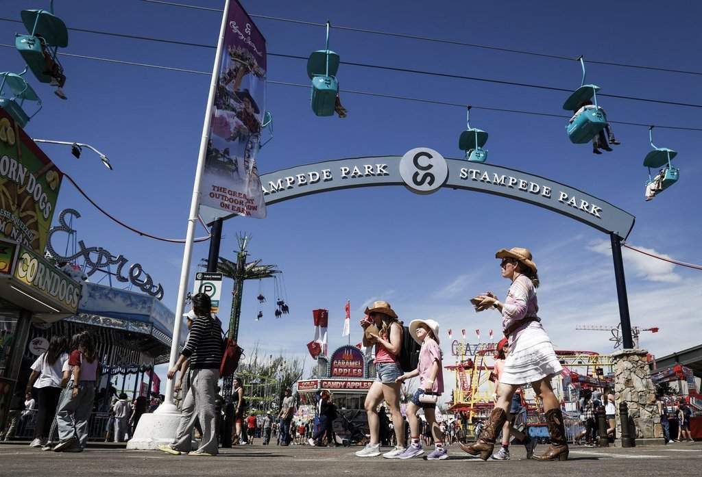 Visitors explore the midway on the final day of the Calgary Stampede in Calgary, Sunday, July 13, 2025. 