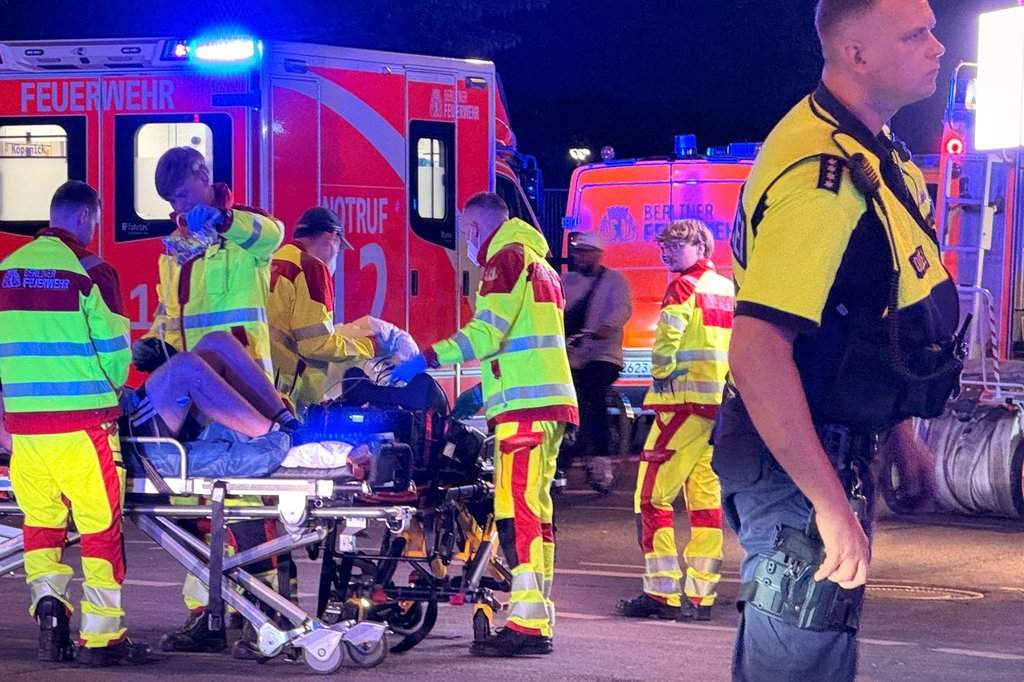 Emergency personnel tend to a person on a stretcher following the cancellation of Christopher Street Day in Berlin on Saturday, July 25, 2026.