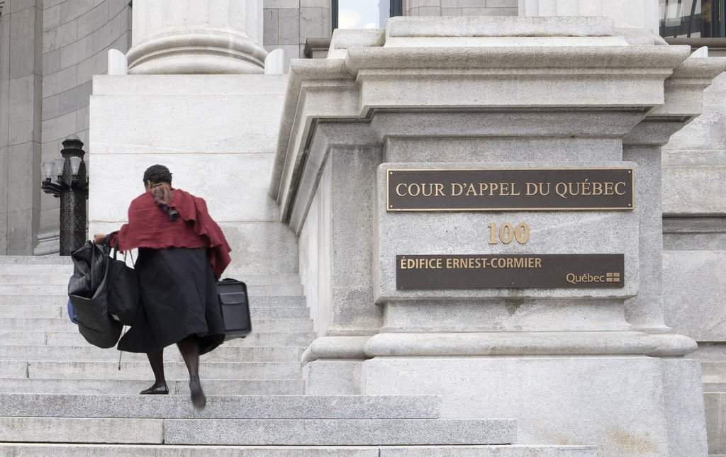A lawyer runs up the steps of the Quebec Court of Appeal in Montreal on Tuesday, April 21, 2026.  