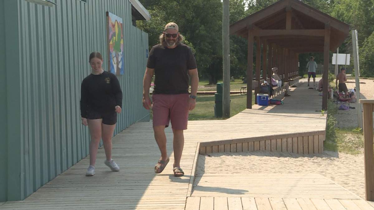 Chad English and his daughter, Sophie English, on the boardwalk at Kenora’s Coney Island.