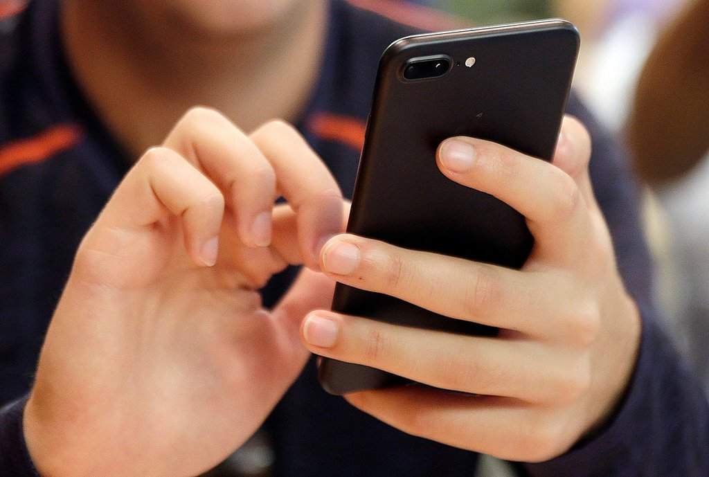 FILE - A person uses a smart phone.