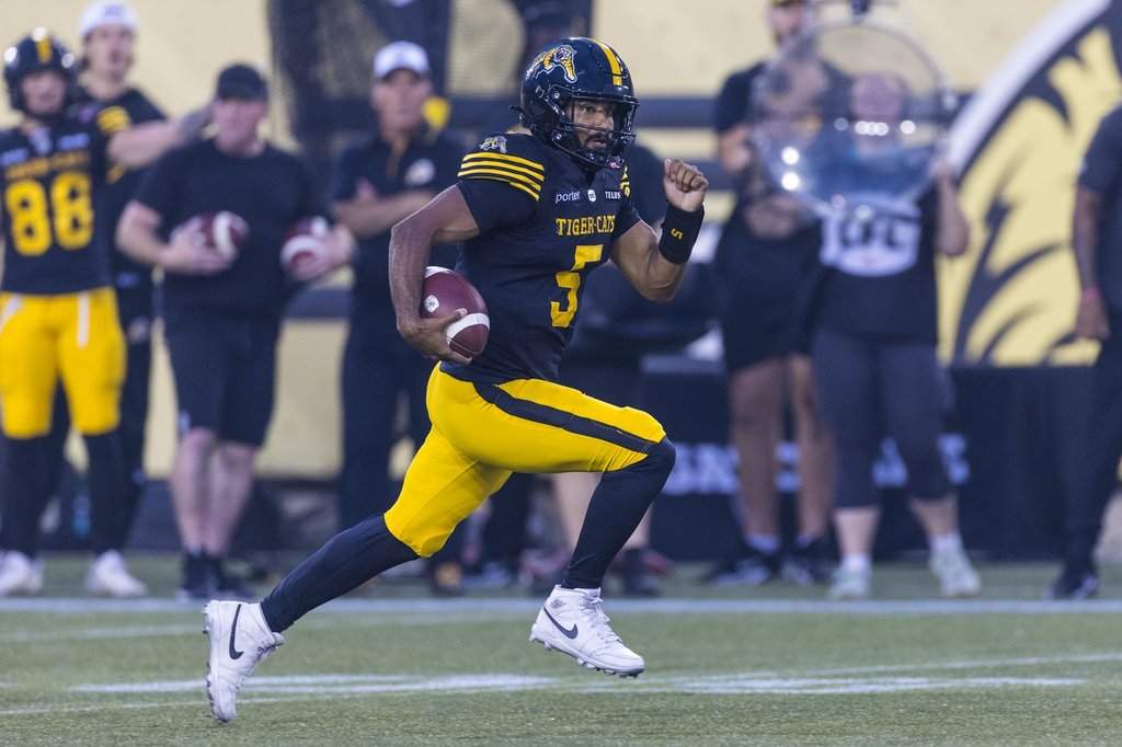 Hamilton Tiger-Cats' Tre Ford carries the ball during first half CFL football action against the Toronto Argonauts, in Hamilton on Saturday, July 18, 2026. THE CANADIAN PRESS/Michael P. Hall.
