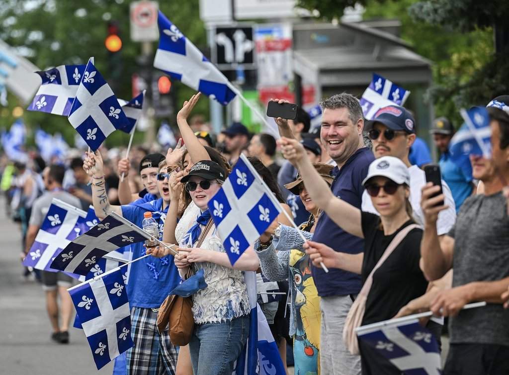 Members of the crowd cheer as they watch the Saint-Jean-Baptiste Day parade in Montreal, on Wednesday, June 24, 2026. 