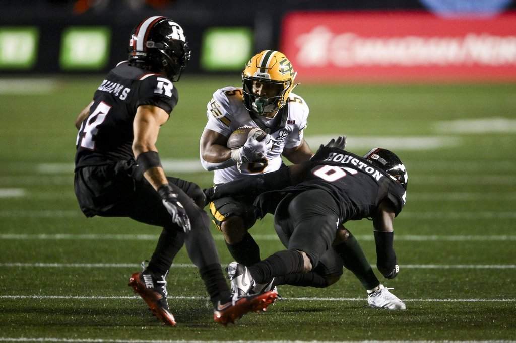 Edmonton Elks' running back Justin Rankin (5) is tackled by Ottawa Redblacks’ defensive back Demerio Houston (6) during second half regular season CFL action in Ottawa, on Saturday, June 6, 2026. THE CANADIAN PRESS/Spencer Colby.