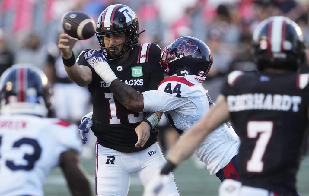 Montreal Alouettes' Kylan Guidry (44) hits Ottawa Redblacks quarterback Jake Maier (13) as he attempts a pass during first half CFL action in Ottawa, Friday, July 31, 2026. 